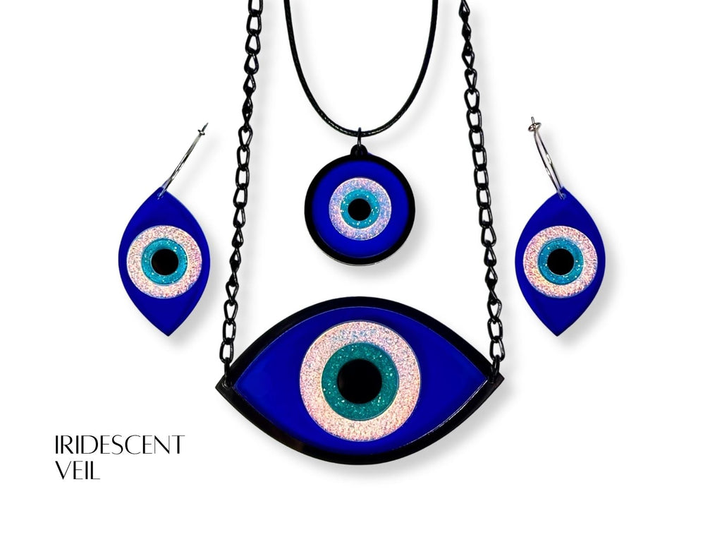 evil eye ritual jewelry set styled flatlay iridescent acrylic talisman collection mythic aesthetic blue white black