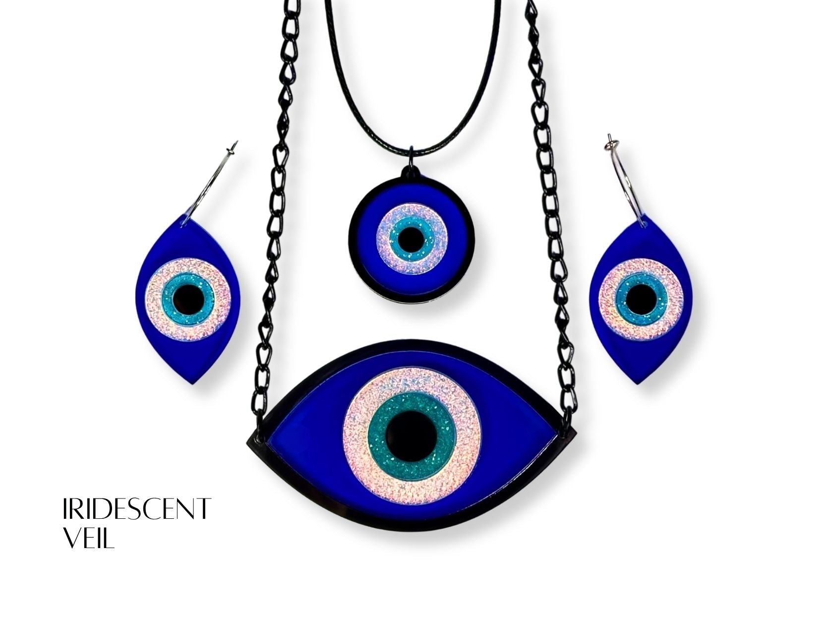 evil eye ritual jewelry set styled flatlay iridescent acrylic talisman collection mythic aesthetic blue white black