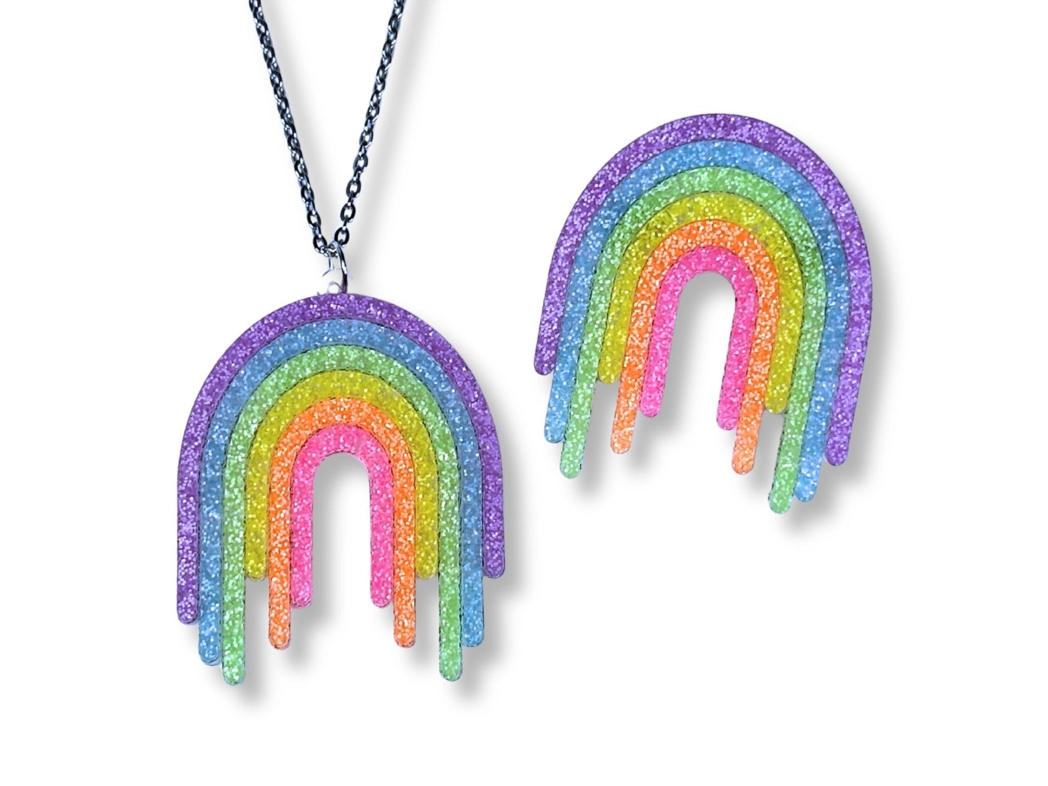 Full Spectrum Rebel Control Set in Rainbow Rave glitter acrylic featuring drip pendant necklace and matching brooch on white background.