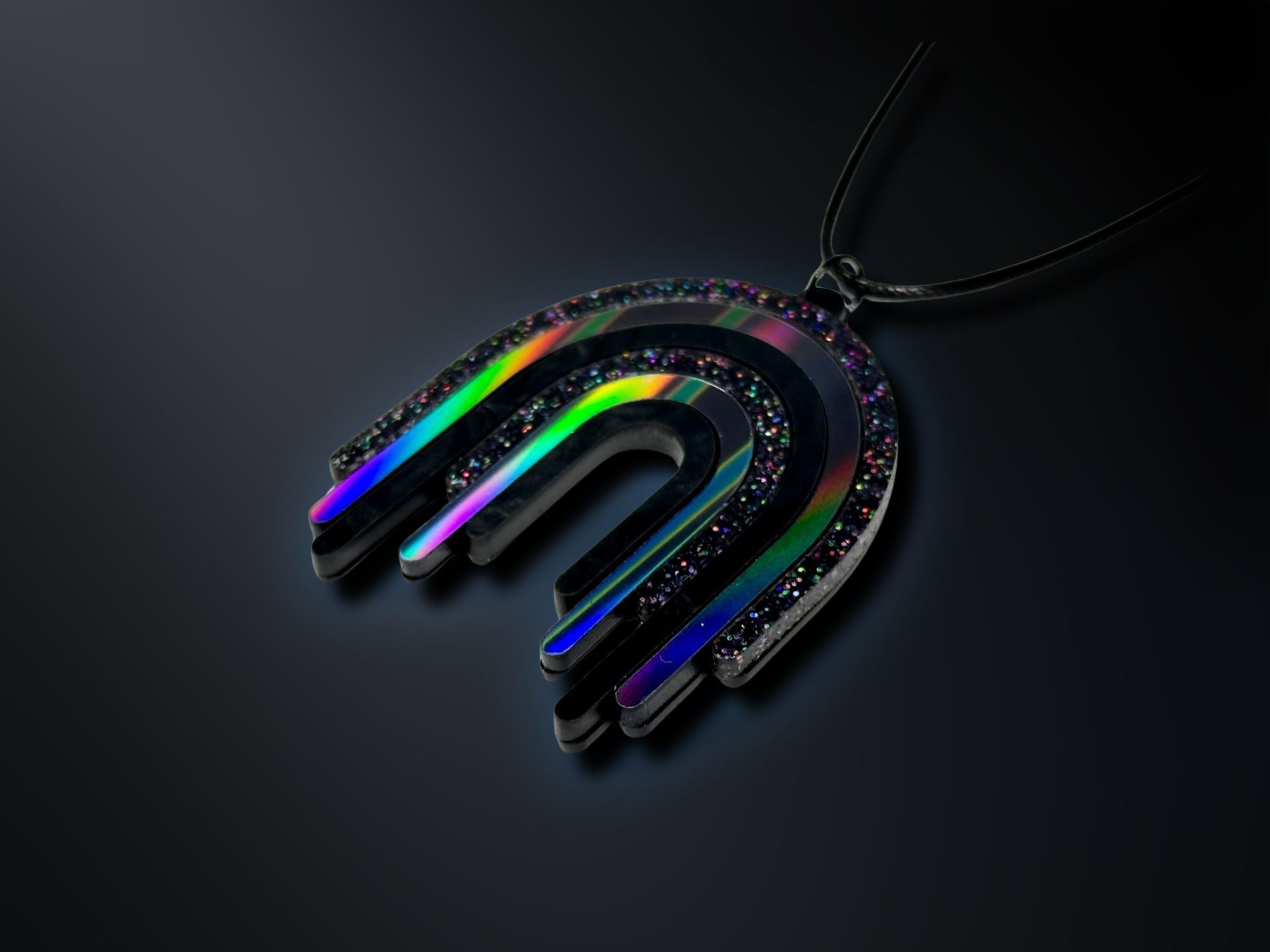 Black Rainbow Drip Pendant photographed on dark background