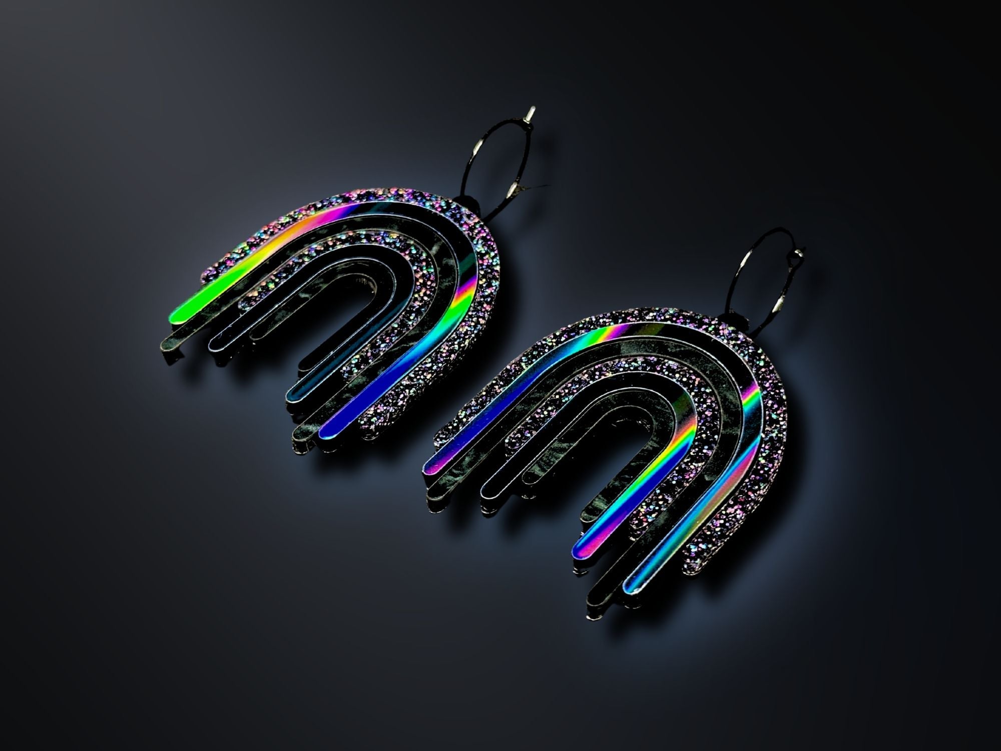Black Rainbow Drip Earrings photographed on dark background