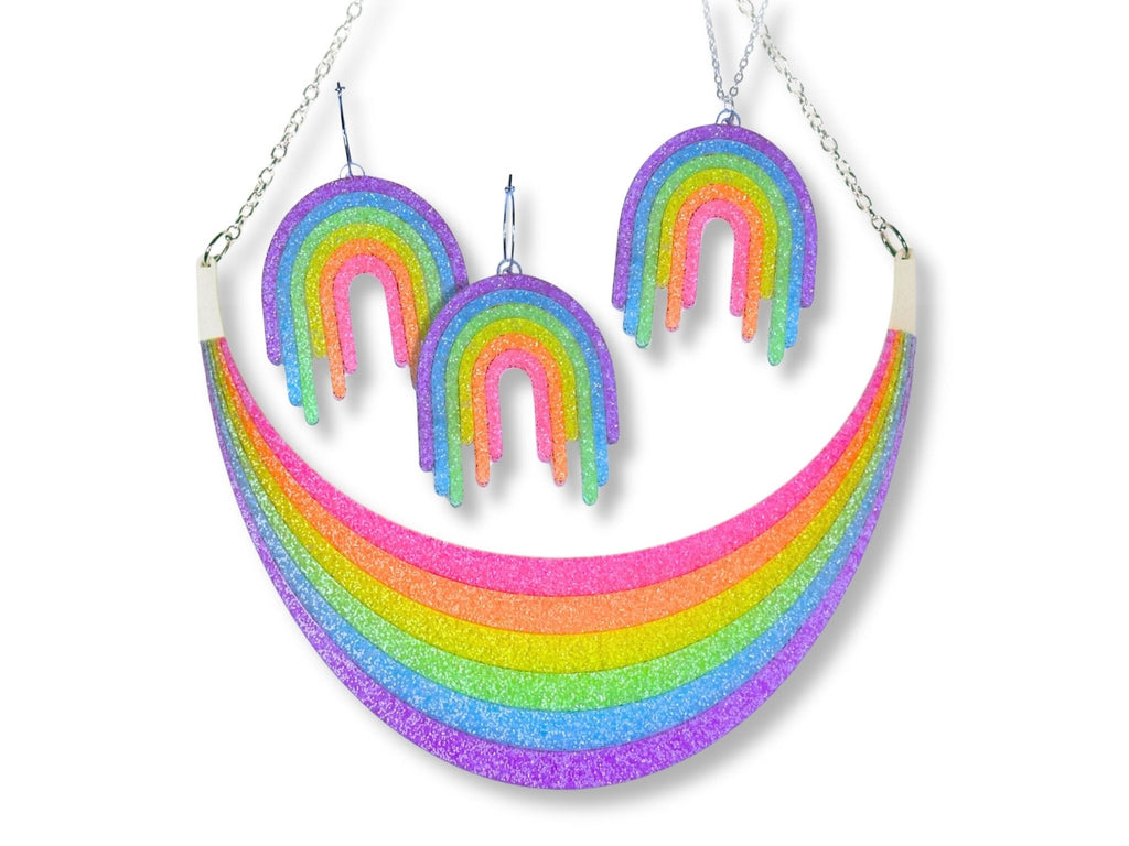 Full Spectrum Rebel Headliner Set in Rainbow Rave glitter acrylic featuring statement necklace, drip pendant, and matching earrings on white background.
