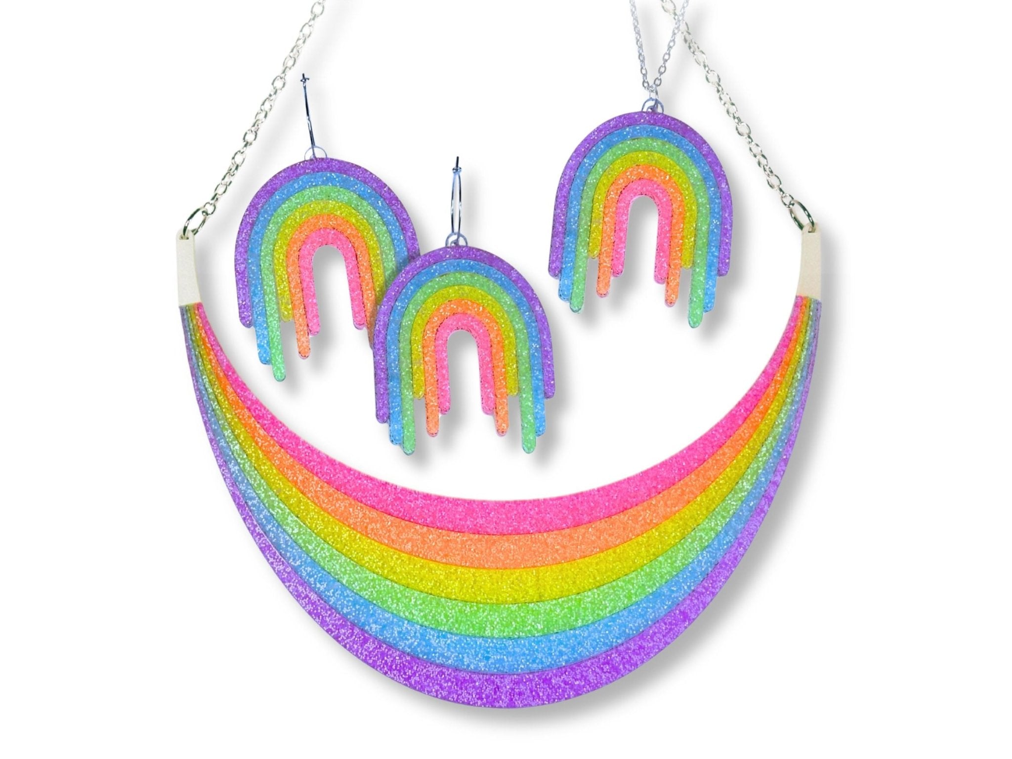 Full Spectrum Rebel Headliner Set in Rainbow Rave glitter acrylic featuring statement necklace, drip pendant, and matching earrings on white background.