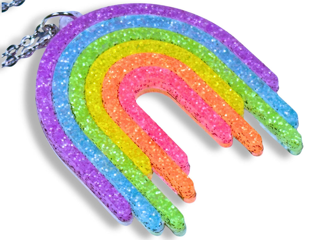 Close-up of Full Spectrum Rebel Rainbow Rave drip pendant in layered glitter acrylic.