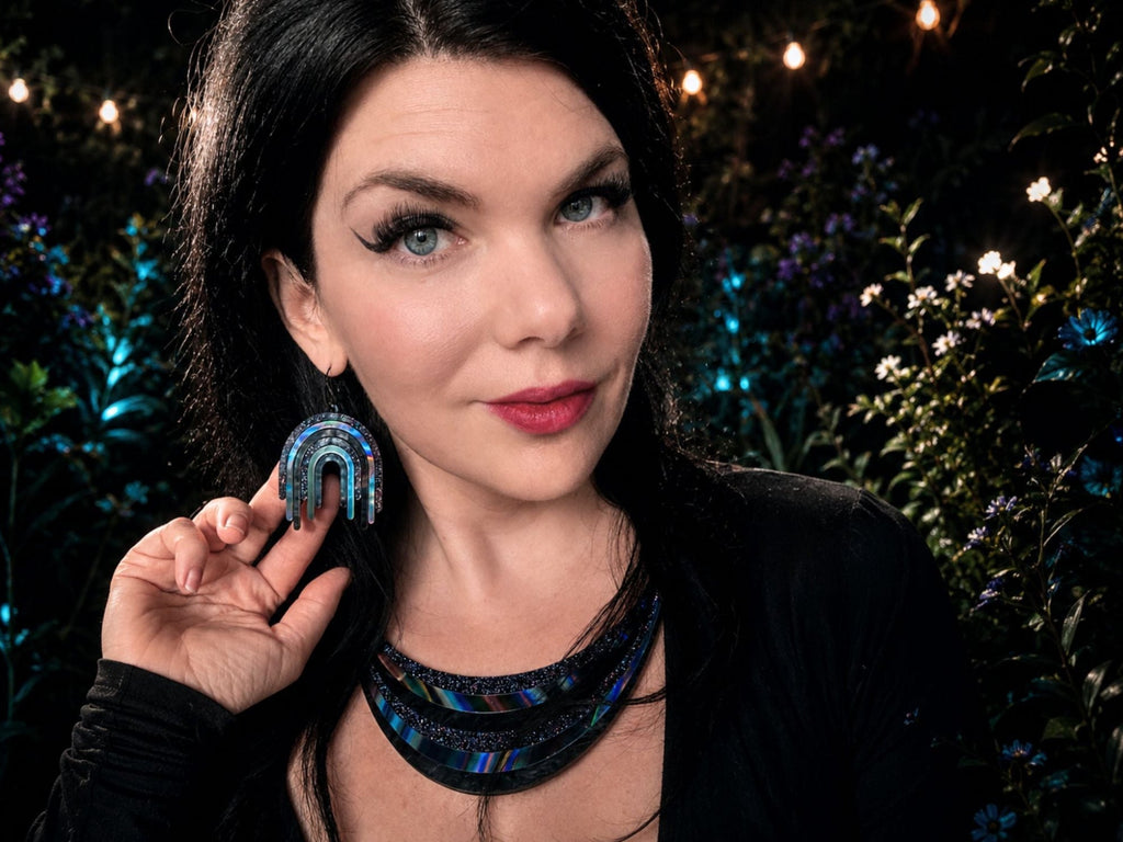 Model wearing Full Spectrum Rebel Arc Necklace and matching Drip Earrings in Black Rainbow