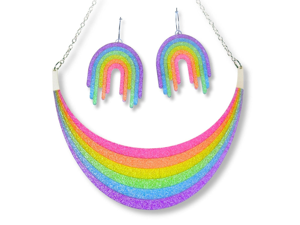 Full Spectrum Rebel Set in Rainbow Rave glitter acrylic featuring statement necklace and drip earrings on white background.