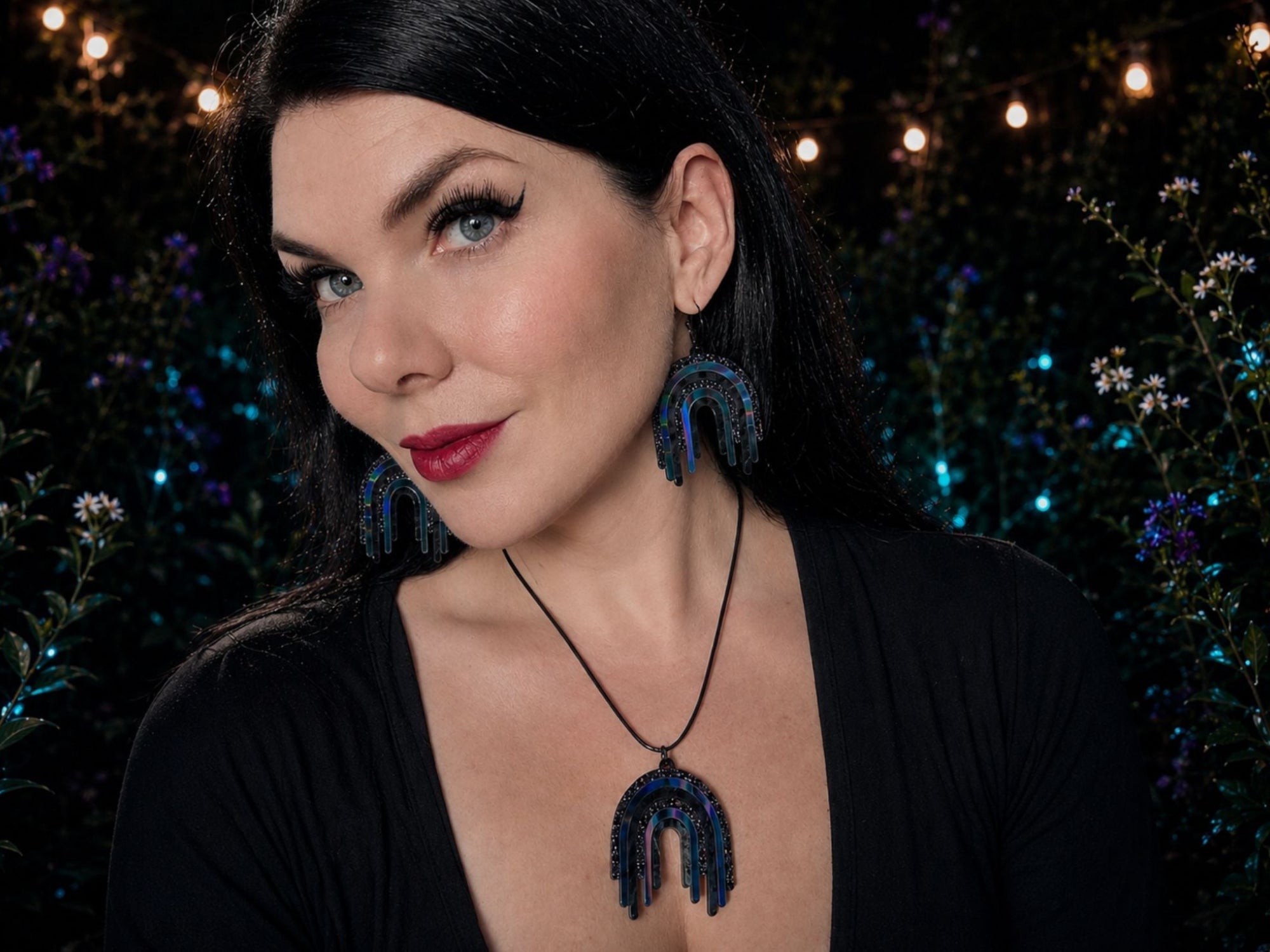 Model wearing Black Rainbow drip earrings and matching pendant necklace
