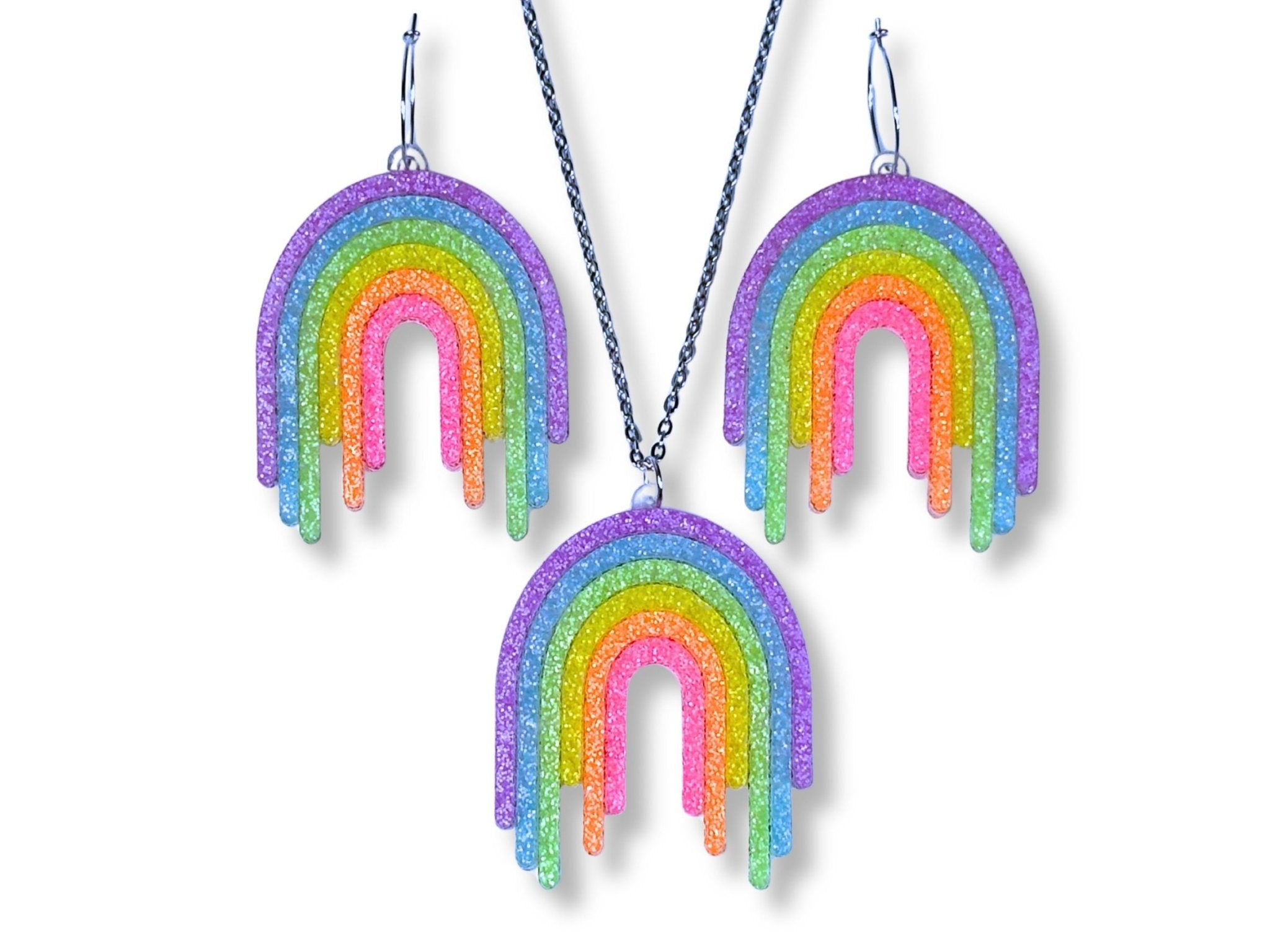 Full Spectrum Rebel Signal Set in Rainbow Rave glitter acrylic featuring rainbow drip pendant and matching earrings on white background.