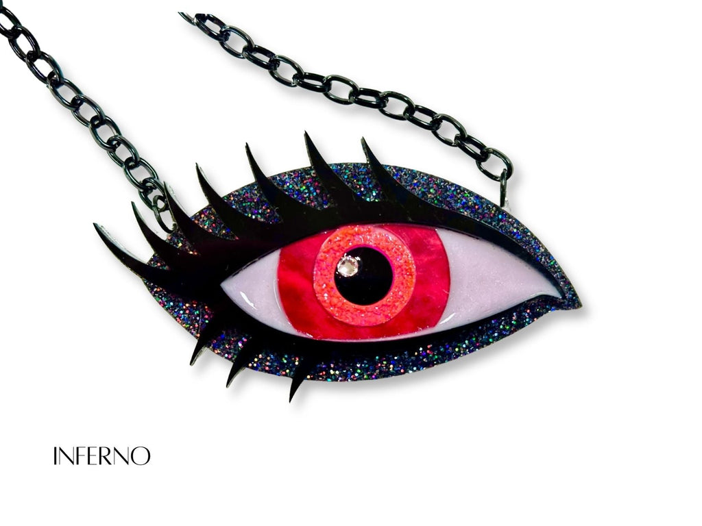 iridescent siren eye necklace styled flatlay mythic talisman jewelry fantasy aesthetic vampire red black holographic glitter