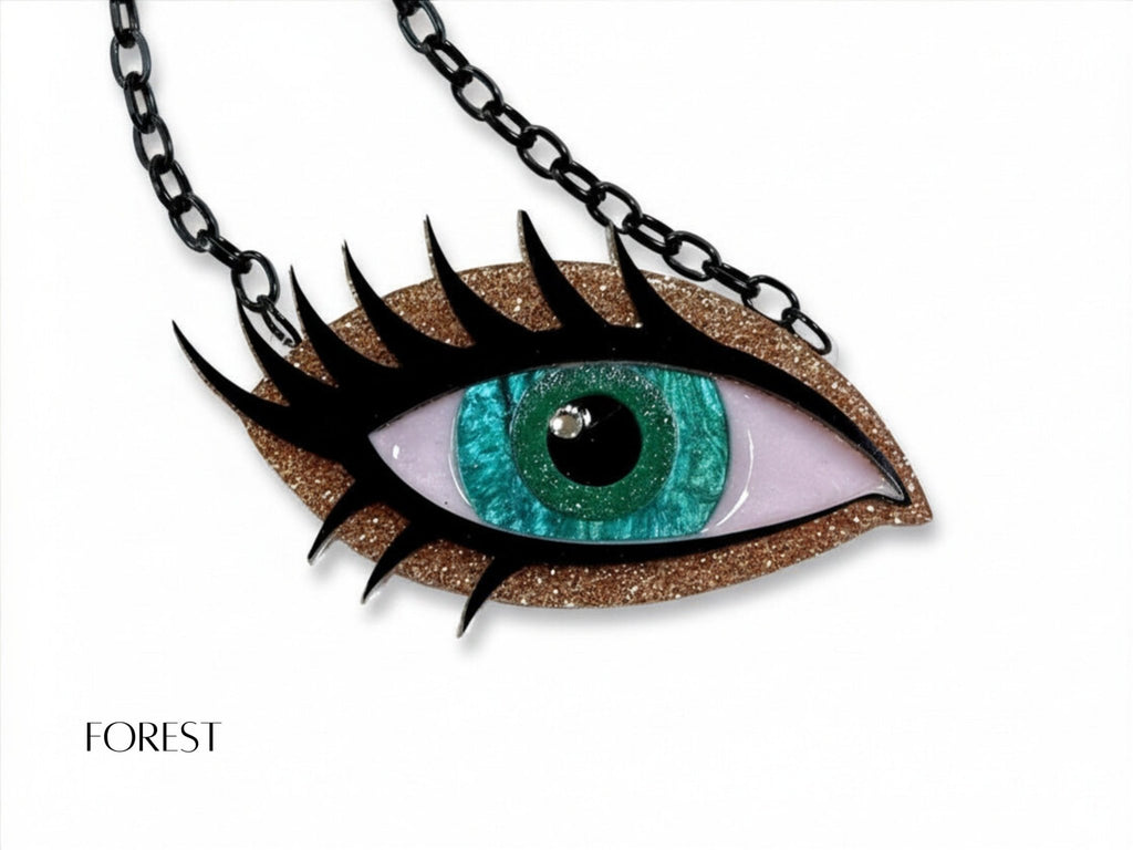 Forest Siren Eye necklace with turquoise green iris, bronze glitter acrylic, dramatic black lashes, and black chain.