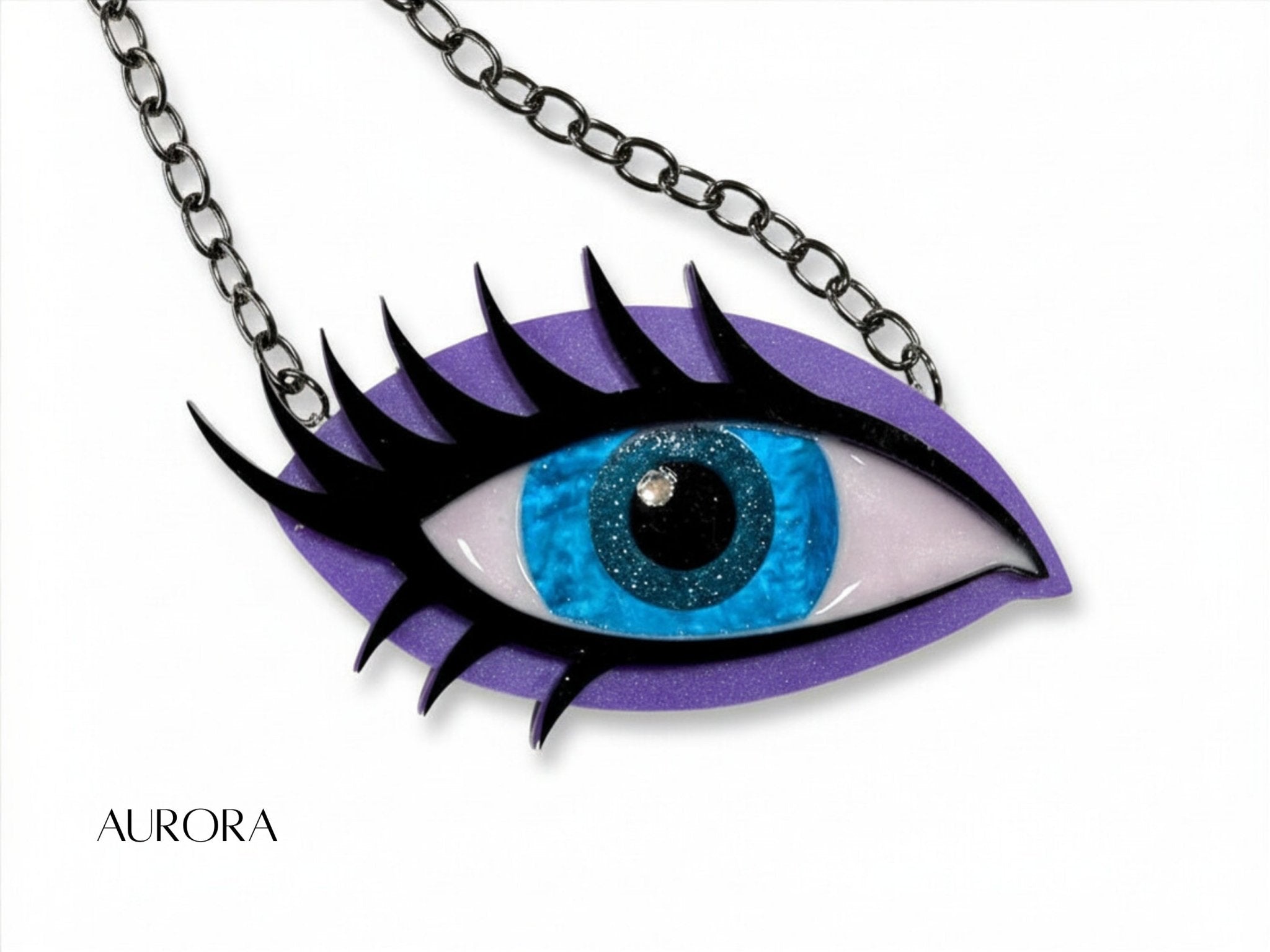 Siren Eye statement necklace in Aurora with a bright blue iris, purple shimmer acrylic, black lashes, and black chain.