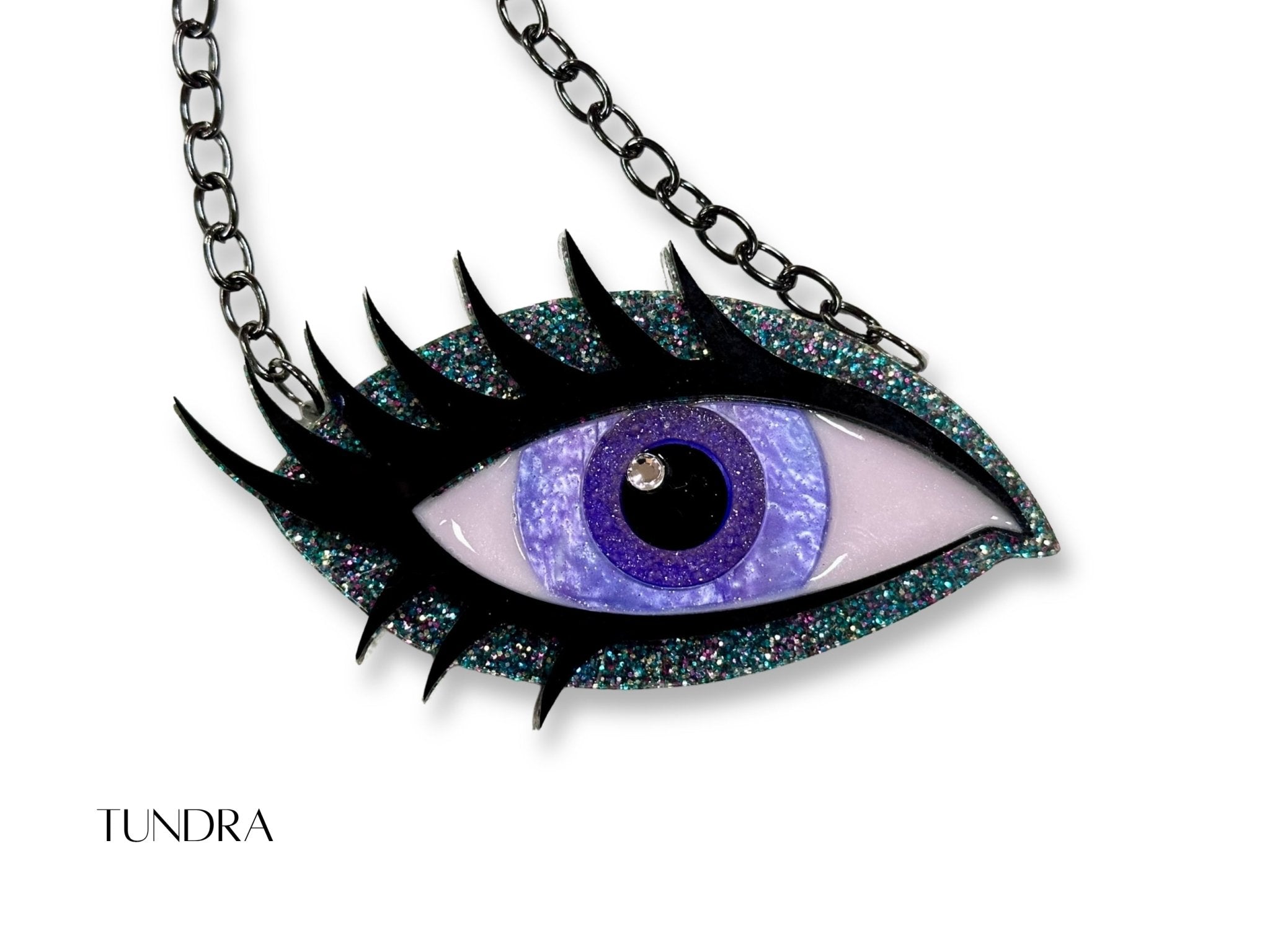 Tundra Siren Eye necklace with lavender iris, teal multicolor glitter acrylic, dramatic black lashes, and black chain.