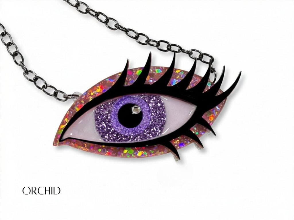 Orchid Siren Eye necklace with sparkling purple iris, pink holographic glitter acrylic, black lashes, and black chain.